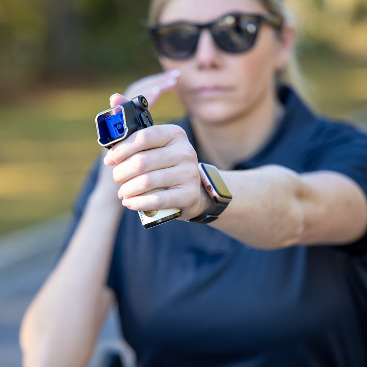 Officer demonstrating OC Kit-A pepper spray holster deployment