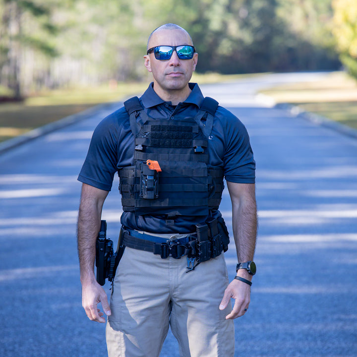 Officer wearing OC Kit-A retention and deployment vest system during patrol movement